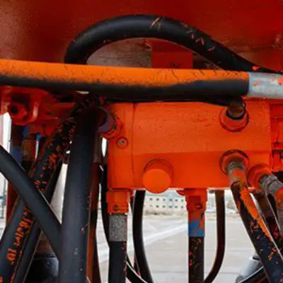 New Project - 2025-04-11T104446.273 A close up of the hydraulic system on an orange vehicle.