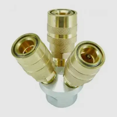 5_2 Three brass couplings are sitting on a white surface.
